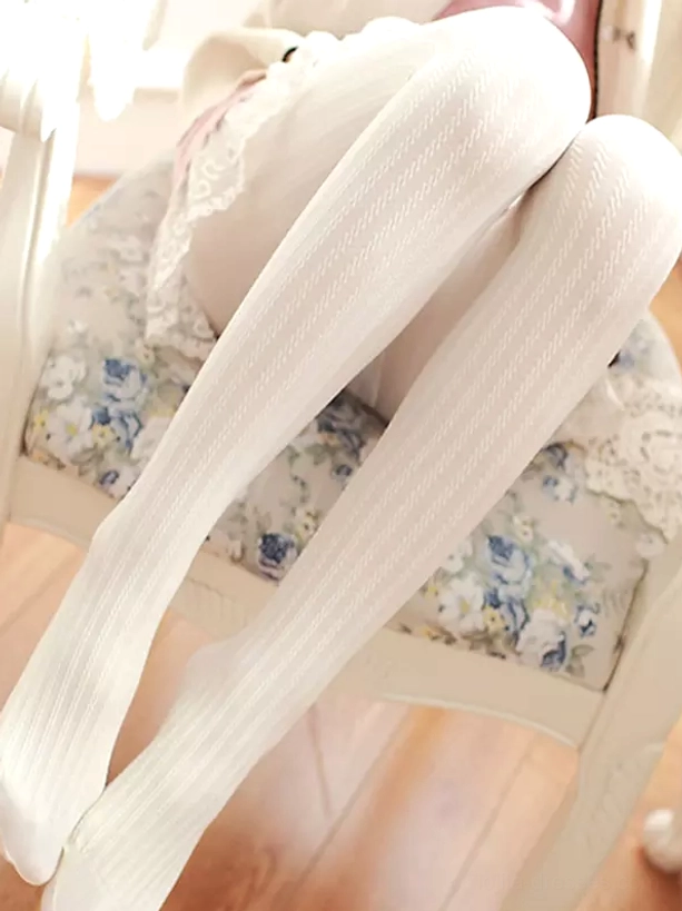 White elegant ribbed Lolita tights with vertical stripe texture worn with classic lace skirt indoor side view showcase