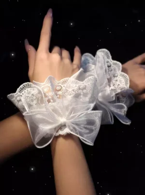 Dual white embroidered lace lolita oversleeves on female hands and forearms featuring large sheer bows and scalloped frilled trim against dark starry backdrop