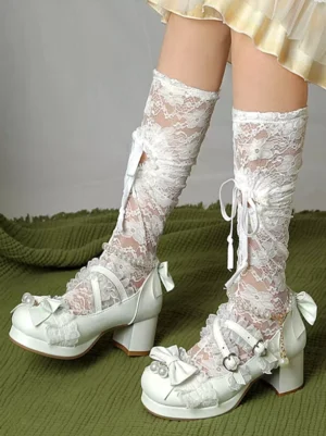 White lolita chunky heel platform pumps side three-quarter view worn with lace ruffle socks and lolita skirt showing bow and pearl embellishments