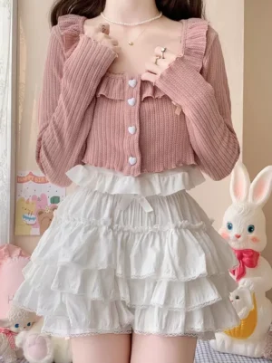 White ruffle sweet lolita bloomers front view worn with pink cropped cardigan in pastel bedroom setting