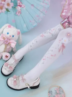 white cherry blossom lolita socks with pink flowers and silver prints paired with pink Mary Jane shoes and frilly lolita dress side leg view