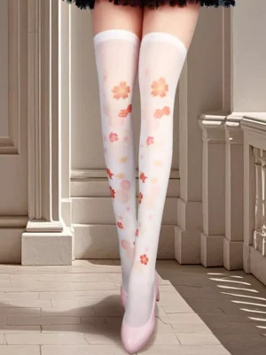 White sakura thigh-high sheer lolita socks with pink cherry blossom floral print worn with pink flats and lace skirt hem detail front view
