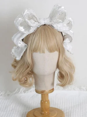 White satin lolita bow headdress with delicate white lace trim - elegant rococo style headband on wooden stand display