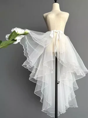 White layered tulle detachable train skirt Sweet Lolita accessory with scalloped ruffled edges and tie-up waistband displayed on mannequin with white flowers