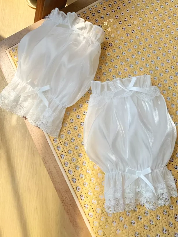 Pure white shiny organza puff oversleeves with lustrous finish, intricate lace trims and white satin bows detail