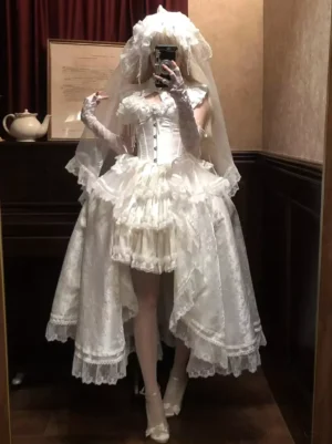 White sleeveless sweet Lolita JSK ball gown with corset bodice and asymmetrical ruffled skirt, front view in ornate tea house setting