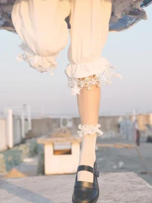 White star fringe cropped lolita bloomers front view close-up low angle with ruffled ankle socks outdoor rooftop setting