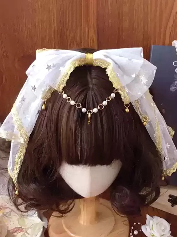 White star mesh lolita bow headdress with gold lace trim and pearl drop chain forehead ornament, front overhead view on mannequin