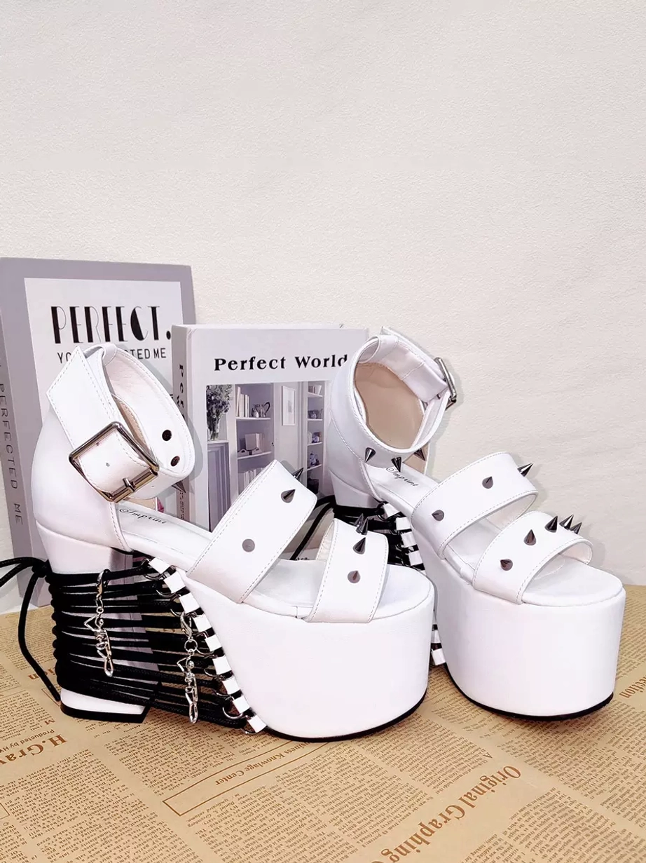 White studded platform Lolita sandals overhead three-quarter flat lay view displaying chain detail on heel, double rivet straps, ankle buckle closure, and overall design aesthetic