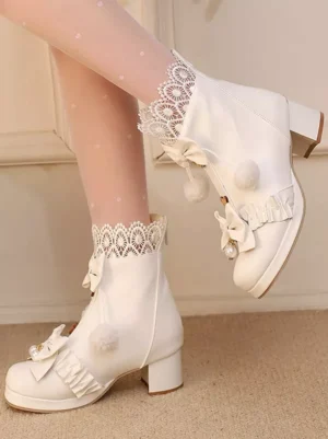 White Sweet Lolita ankle boots with chunky block heel featuring decorative bows and pom-pom trims, shown in single and paired on-foot side view with model wearing dotted lace socks and round toe design