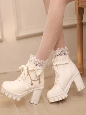 White sweet lolita ankle boots with ruffled lace collar and star chain bow embellishment, side-front pair view with dotted sheer stockings