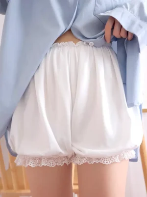 White lolita bloomers back view with soft draping fabric and decorative button detail on waistband worn with light blue shirt