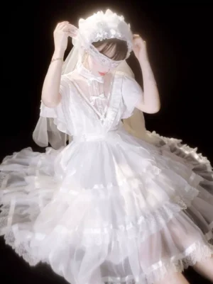 White romantic lolita dress close-up front view showing sheer neckline panel and layered ruffled tulle hemline details