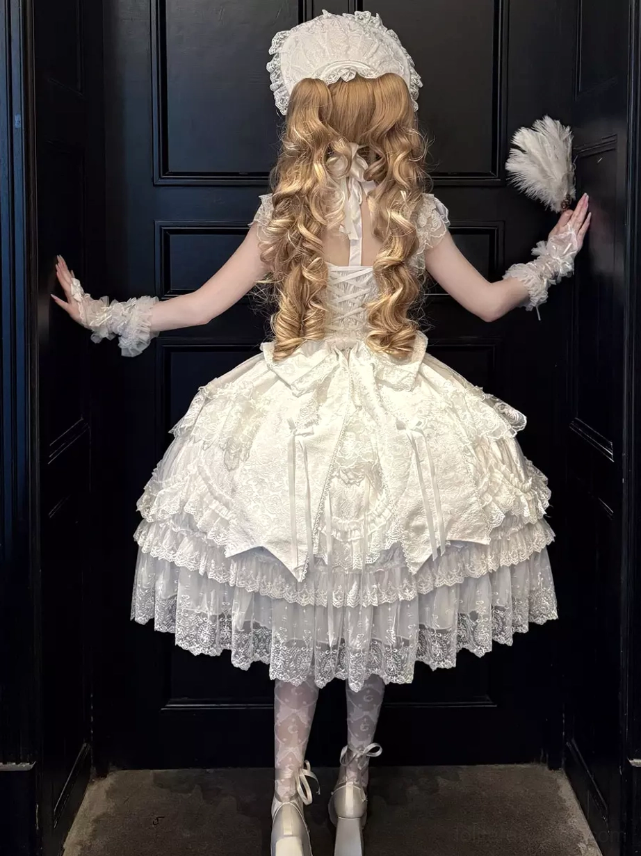 White sweet lolita ball gown back view showcasing open back design and large back bow with lace trim