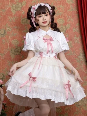 White Sweet Lolita dress with tiered ruffles and puff sleeves, featuring pink bow decorations and hollow chest cutout, full-body front view on model with pink hair ribbons against vintage floral backdrop