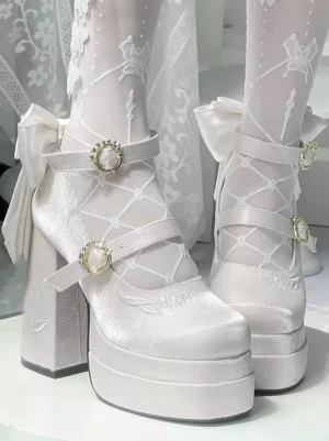 White Sweet Lolita platform Mary Jane heels with gem buckles and satin back bow, worn with lace stockings and displayed against lace backdrop