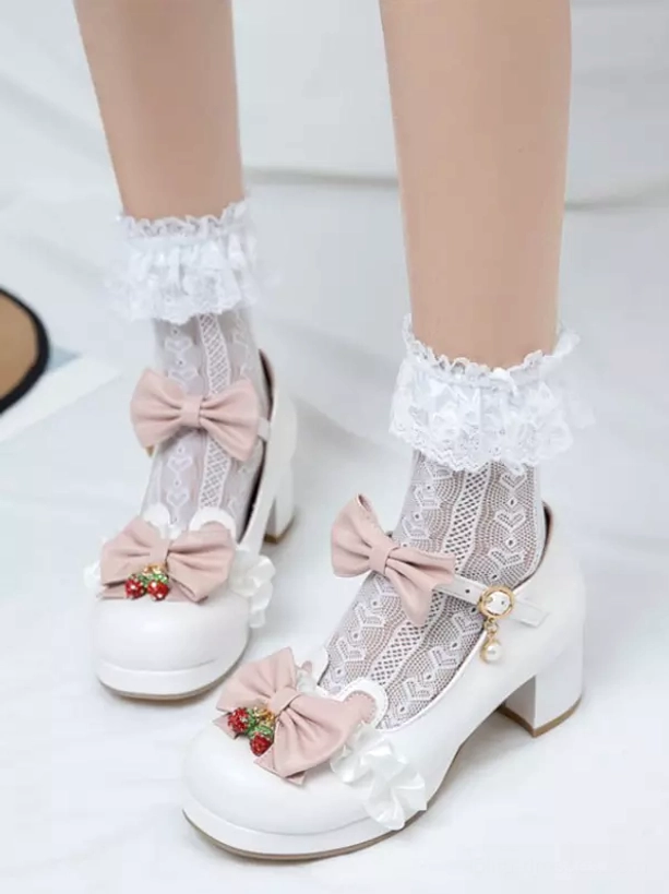 White Sweet Lolita Mary Jane pumps with pink bows and strawberry charms shown on-foot from top-down angle, featuring chunky block heel and ruffled lace ankle socks