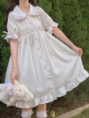 white sweet lolita op dress ruffled peter pan collar bow sleeves three-quarter view outdoor green background