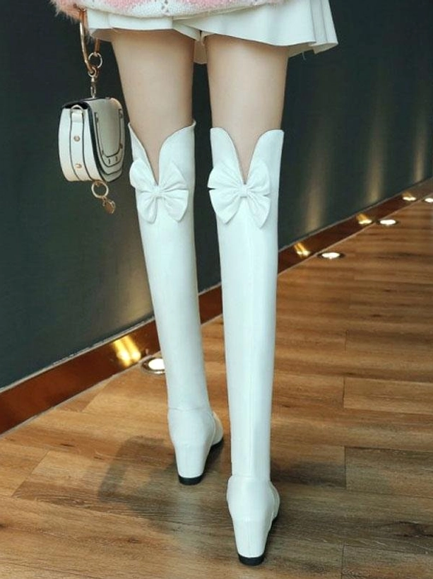White over-the-knee sweet lolita boots with front bow decoration back view model wearing mini skirt