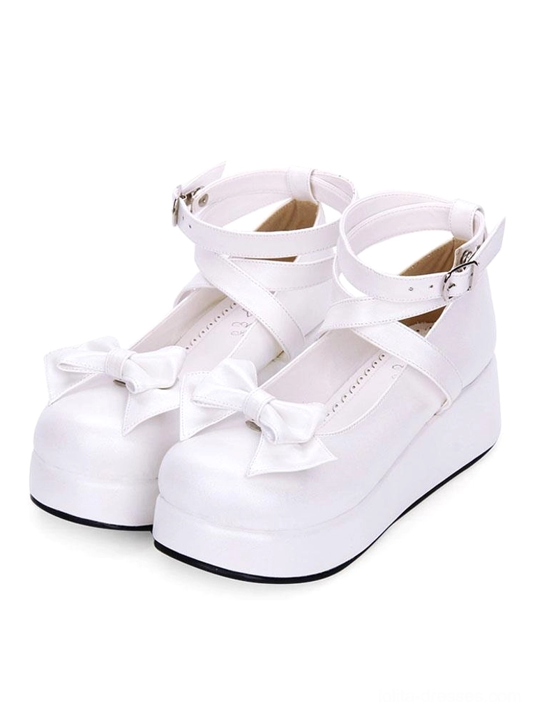 White Sweet Lolita platform shoes with bright white leather finish, toe bow, and double ankle straps three-quarter front view on plain white background