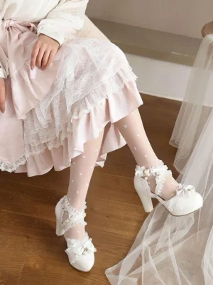 White Lolita pumps with lace trim bow and pearl accents block heel seated lower body view worn with white ruffled Lolita skirt