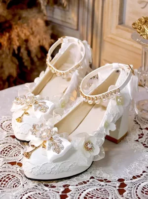 White sweet lolita pumps with pearl rhinestone ankle strap and floral bow embellishments on vintage wooden door background lolita shoes