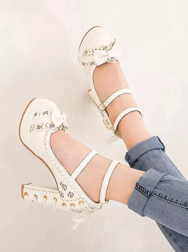White sweet lolita pumps overhead top-down view with rolled jeans showing floral vamp print, lace-up block heel and ankle strap detail