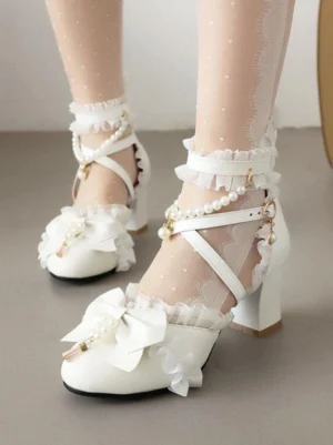 White Sweet Lolita sandals with pearl ankle straps and ruffled bow detail, round toe, chunky block heel, front overhead view on model with lace stockings