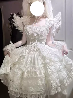 White sweet lolita wedding dress with lace-up corset bodice and multi-tiered ruffled skirt front view on model with angel wing accessories