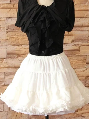 white tiered lolita petticoat full front view mannequin display showing a-line silhouette and layered ruffled hem with black blouse