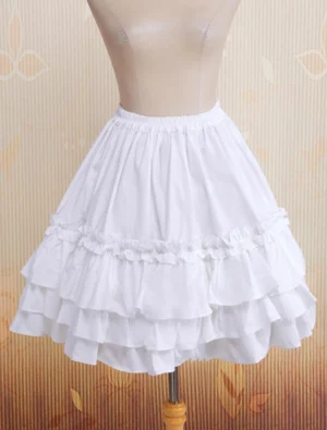White multi-layer tiered ruffle cotton lolita skirt front view on mannequin, showing elastic waistband and cascading ruffled hem layers, sweet lolita fashion style