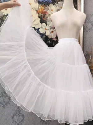 white tiered tulle lolita petticoat side view with lifted skirt showing three-layered ruffled construction sheer tulle fabric