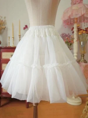 white tulle lolita petticoat with tiered ruffles elastic waistband fluffy pleated silhouette side view mannequin vintage home setting