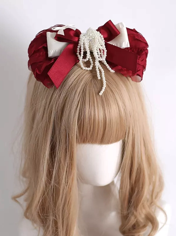 Wine red lolita bow hair clip headdress with cream ruffled fabric and pearl tassel worn on mannequin front view with light brown bangs
