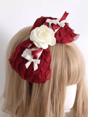 Wine red lolita hairband headdress with ruffled chiffon bows and white rose accents displayed on mannequin rear side view with blonde hair