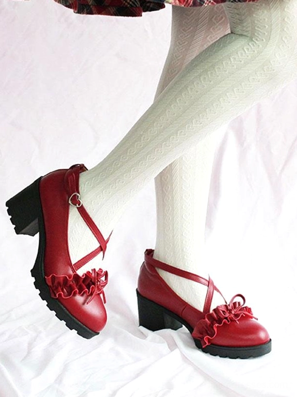 Wine red Lolita leather shoes side rear view of wearing feet, model in light green textured tights, ruffle bow cross strap detail visible on round chunky heel