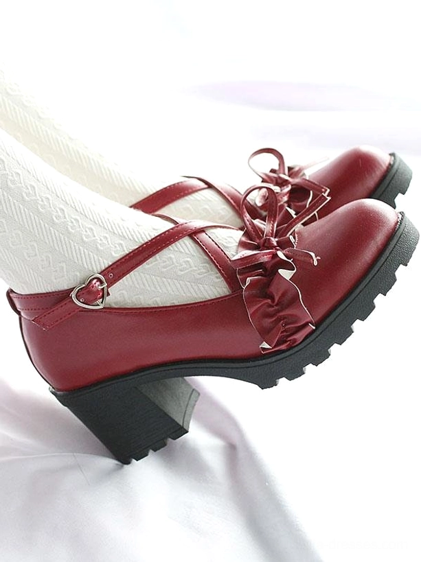 Wine red Lolita shoes close-up overhead side view partially visible model in white tights, rugged sole detail, buckle cross straps with ruffle bow embellishment