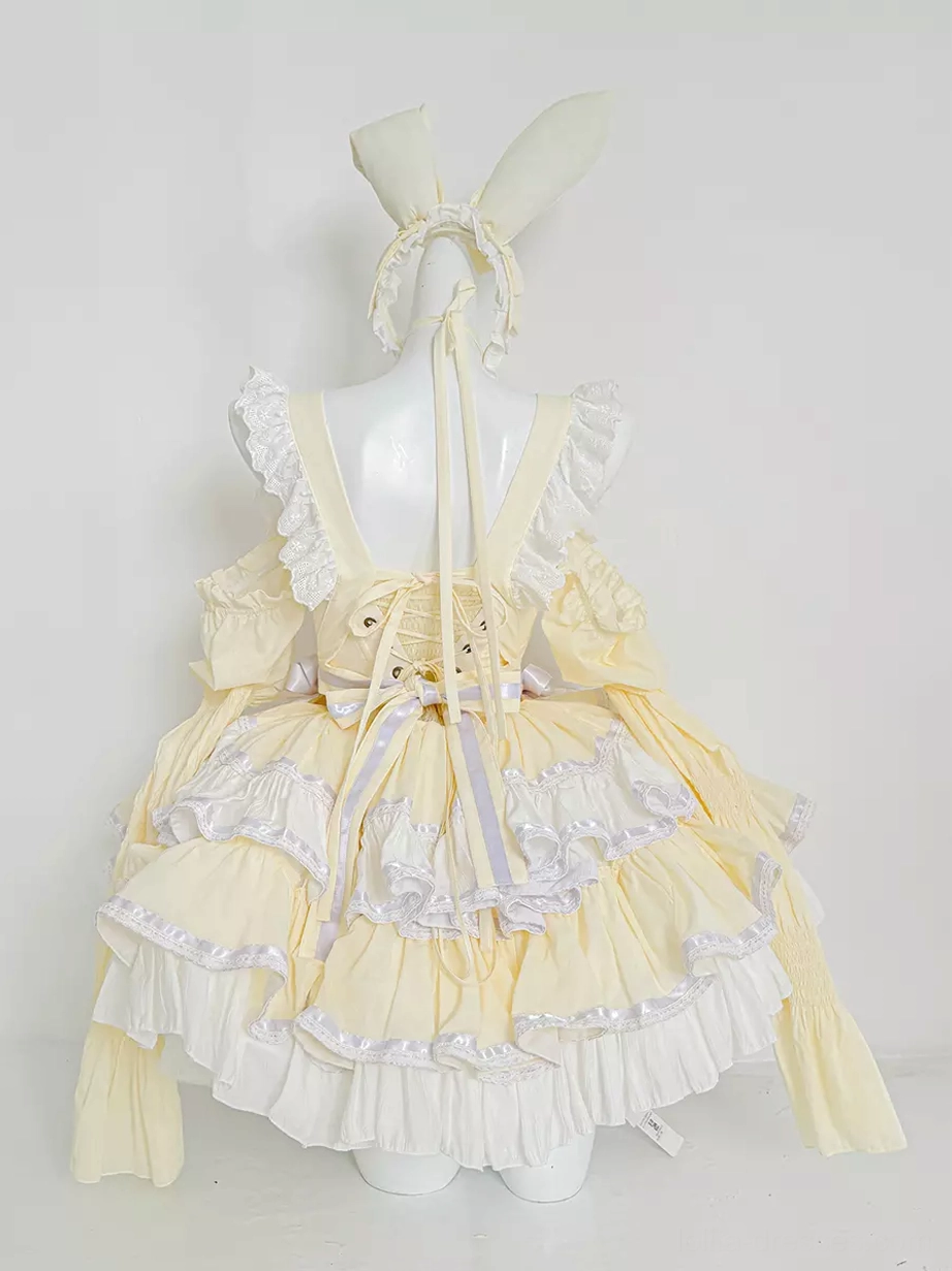 Back view of yellow rabbit maid lolita dress showing lace-up corset back closure, large purple ribbon bow, and layered ruffled skirt construction