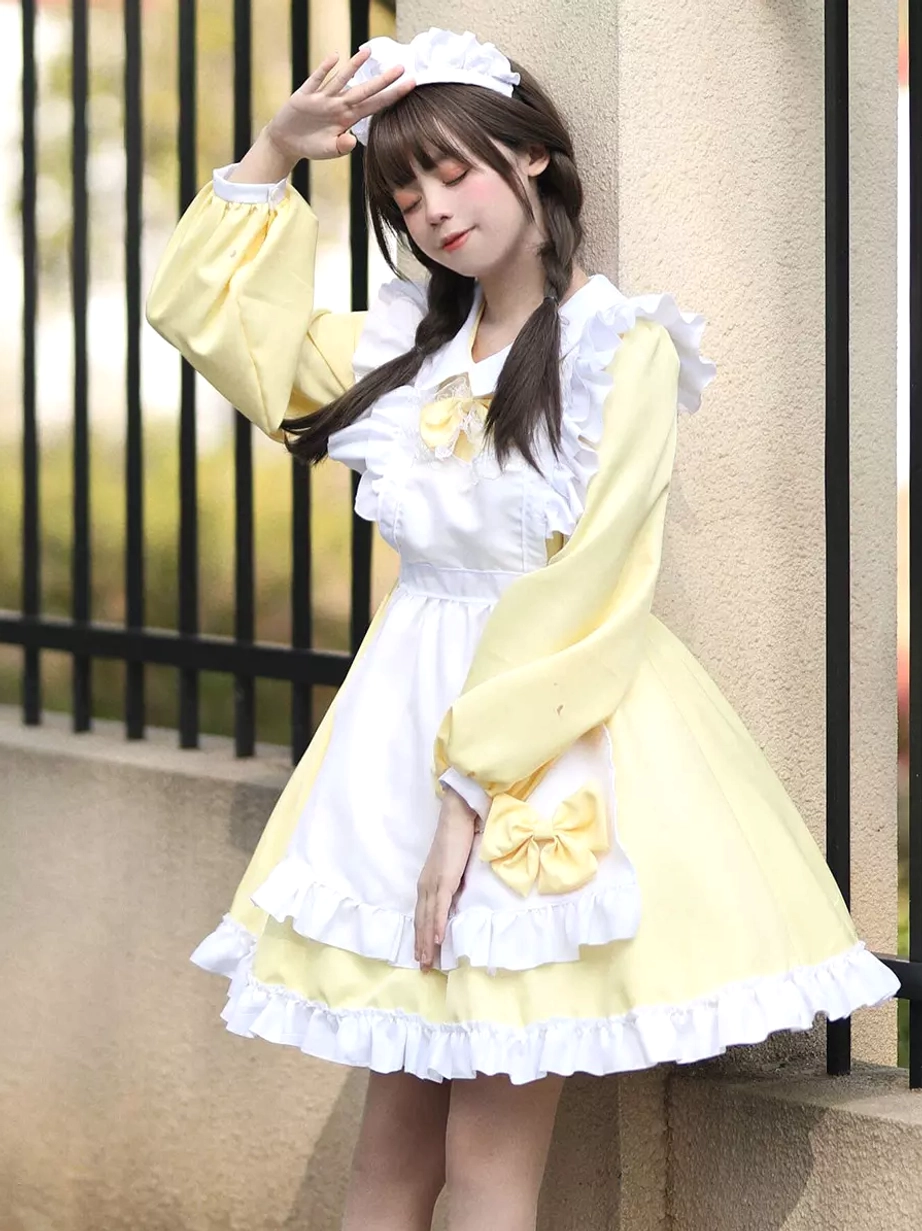 Yellow and white maid lolita mini dress with bow decorations and maid headband worn in outdoor setting